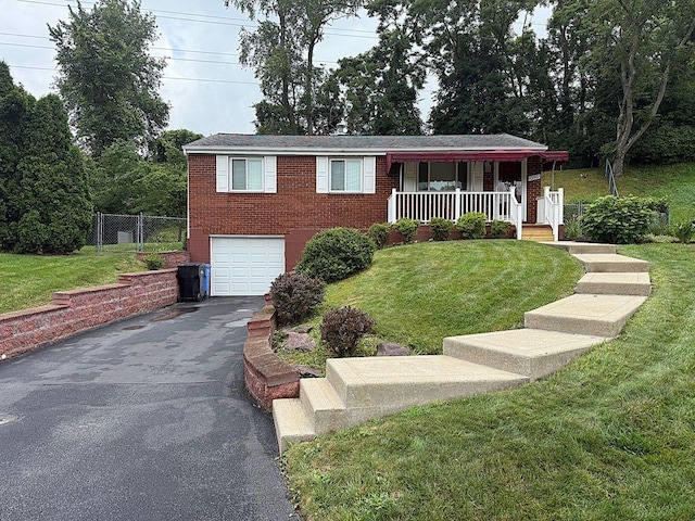 13901 Harvie Ct, North Huntingdon, PA 15642 - ranch-style house with a garage, asphalt driveway, covered porch, and brick siding