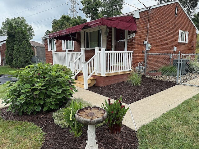 13901 Harvie Ct, North Huntingdon, PA 15642 - view of front facade featuring brick siding, covered porch, and a gate