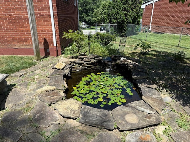 13901 Harvie Ct, North Huntingdon, PA 15642 - exterior view of a small pond and brick siding