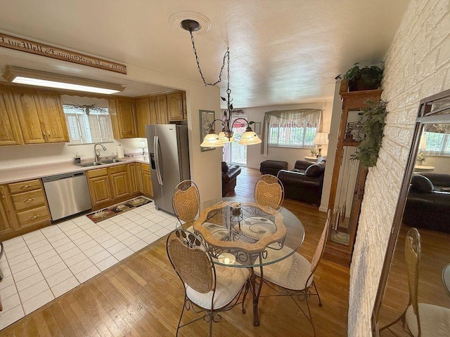 13901 Harvie Ct, North Huntingdon, PA 15642 - dining area with light wood-style flooring and a chandelier
