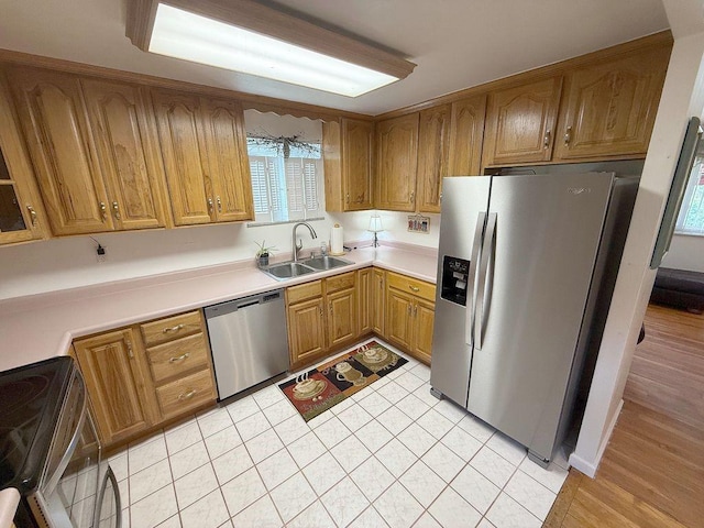 13901 Harvie Ct, North Huntingdon, PA 15642 - kitchen featuring appliances with stainless steel finishes, brown cabinets, healthy amount of natural light, and light countertops