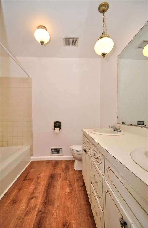 306 Barbara Dr, Carroll Twp, PA 15063 - full bath with wood finished floors, double vanity, and shower / bath combination
