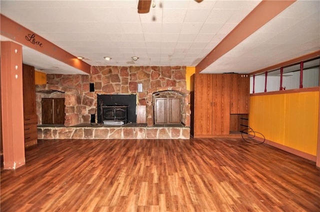 306 Barbara Dr, Carroll Twp, PA 15063 - unfurnished living room with wood finished floors, a wood stove, and wooden walls