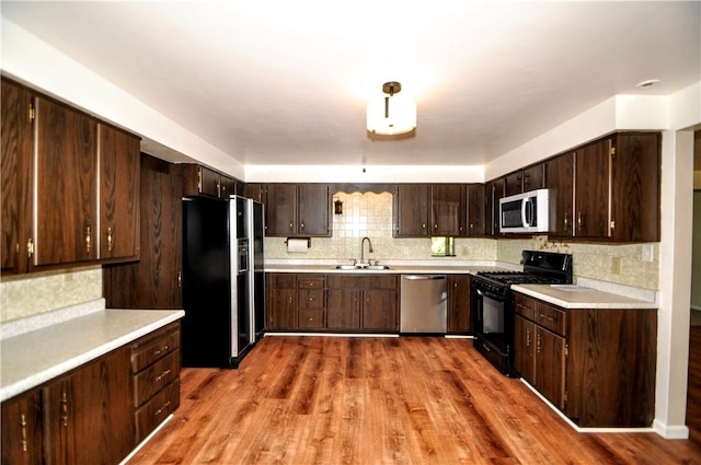 306 Barbara Dr, Carroll Twp, PA 15063 - kitchen with black appliances, light countertops, and tasteful backsplash