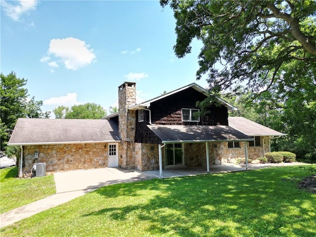 306 Barbara Dr, Carroll Twp, PA 15063 - view of front of home with stone siding, a front lawn, a chimney, and a patio