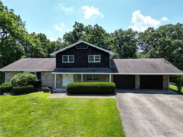 306 Barbara Dr, Carroll Twp, PA 15063 - traditional-style home featuring stone siding, driveway, an attached garage, and a front lawn