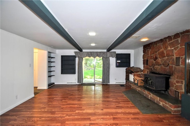 306 Barbara Dr, Carroll Twp, PA 15063 - unfurnished living room with beamed ceiling, wood finished floors, and a wood stove