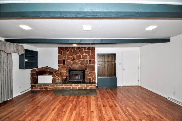 306 Barbara Dr, Carroll Twp, PA 15063 - unfurnished living room featuring beamed ceiling, wood finished floors, a wood stove, and a baseboard heating unit