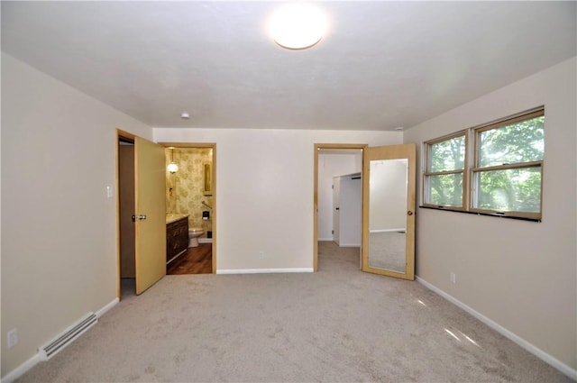 306 Barbara Dr, Carroll Twp, PA 15063 - unfurnished bedroom featuring carpet, baseboard heating, and connected bathroom