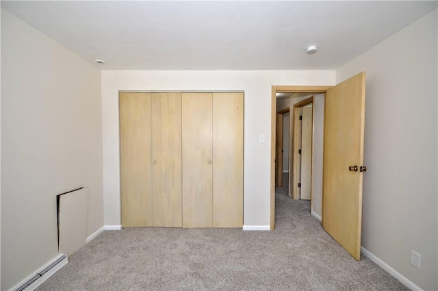 306 Barbara Dr, Carroll Twp, PA 15063 - unfurnished bedroom featuring a baseboard radiator, light carpet, and a closet