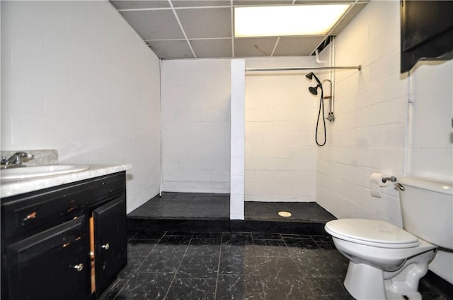 306 Barbara Dr, Carroll Twp, PA 15063 - bathroom with tiled shower, vanity, concrete block wall, and a paneled ceiling