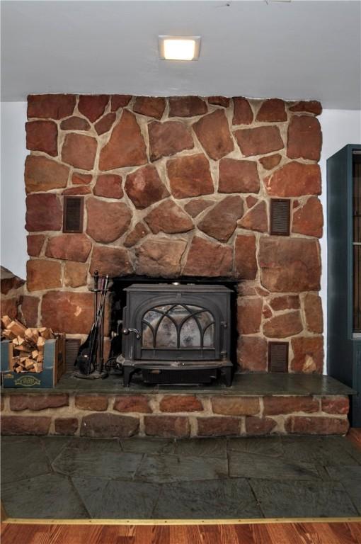 306 Barbara Dr, Carroll Twp, PA 15063 - detailed view of a wood stove and wood finished floors