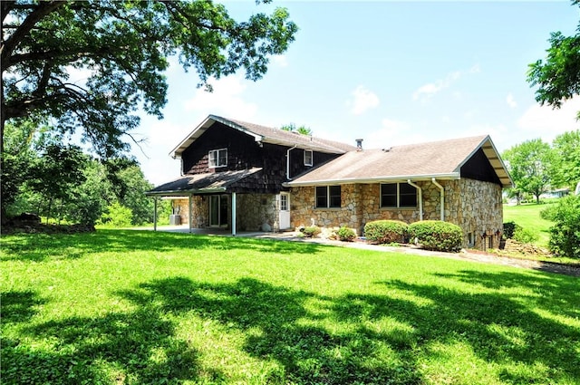 306 Barbara Dr, Carroll Twp, PA 15063 - rear view of property with stone siding and a yard