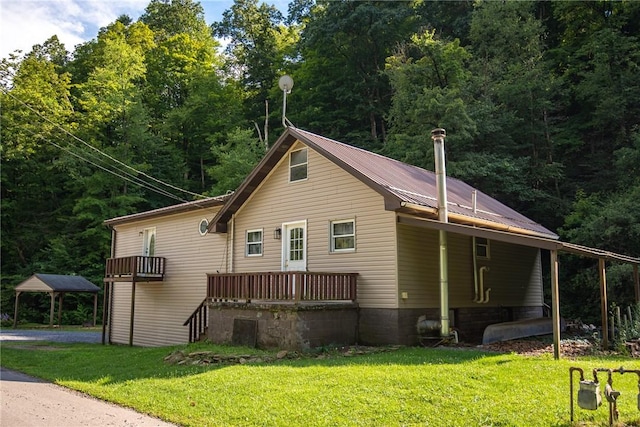 151 Cove Run Rd, Bradys Bend Twp, PA 16028 - view of side of home with a lawn, a metal roof, and a forest view