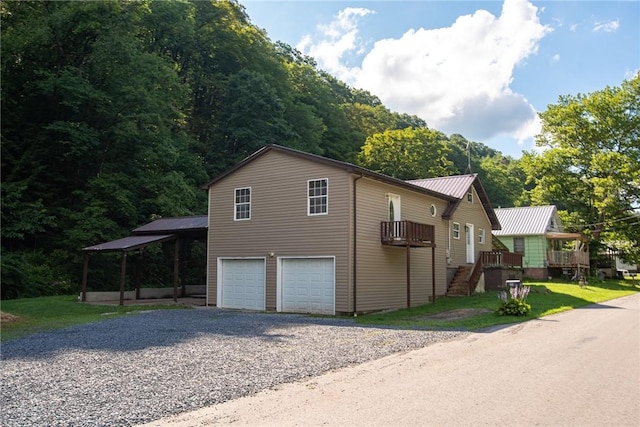 151 Cove Run Rd, Bradys Bend Twp, PA 16028 - view of side of home featuring a garage, a metal roof, driveway, and stairs