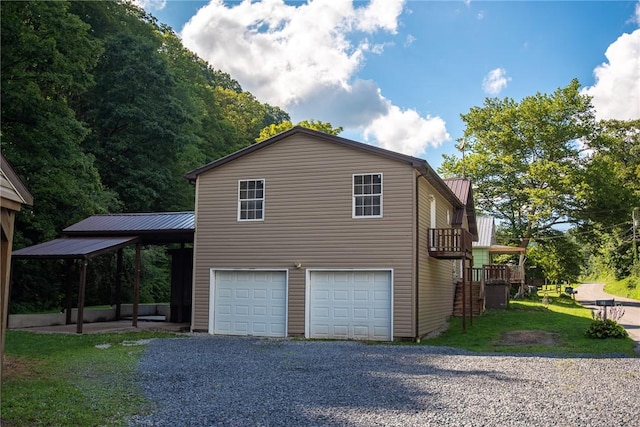 151 Cove Run Rd, Bradys Bend Twp, PA 16028 - view of property exterior with a garage, gravel driveway, and a metal roof
