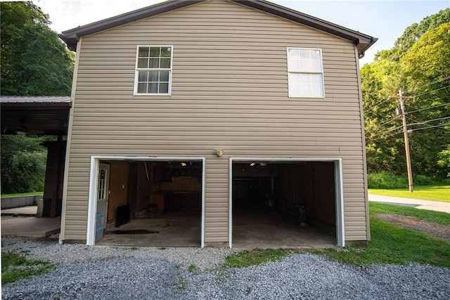 151 Cove Run Rd, Bradys Bend Twp, PA 16028 - view of property exterior featuring an attached garage and gravel driveway