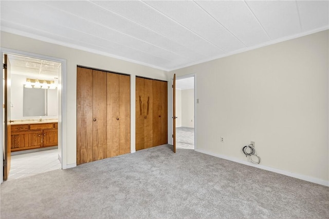 820 E Beau St Unit Tlc, South Strabane, PA 15301 - unfurnished bedroom with light carpet, two closets, ornamental molding, and ensuite bathroom