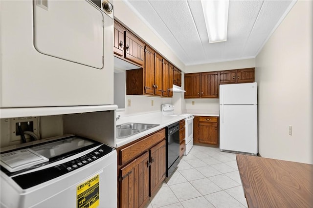 820 E Beau St Unit Tlc, South Strabane, PA 15301 - kitchen featuring freestanding refrigerator, range with electric stovetop, estacked washer and dryer, light countertops, and light tile patterned floors