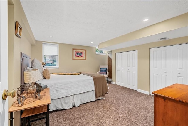 2001 Buckingham Dr, Marshall, PA 16046 - carpeted bedroom with multiple closets, multiple windows, a textured ceiling, recessed lighting, and heating unit