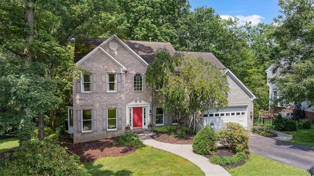 2001 Buckingham Dr, Marshall, PA 16046 - colonial-style house with brick siding, an attached garage, and asphalt driveway