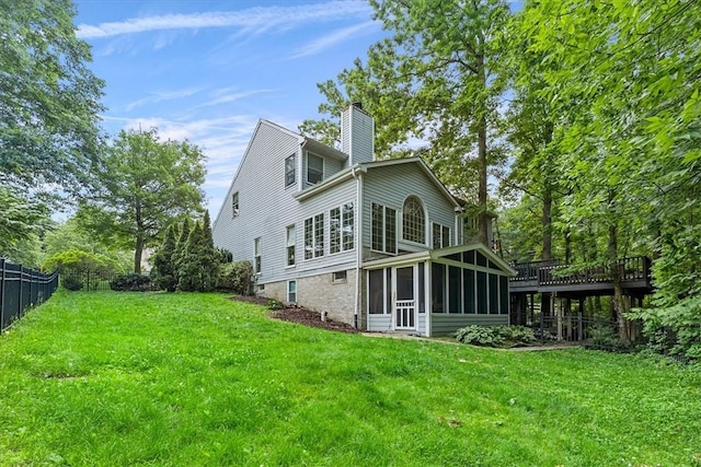 2001 Buckingham Dr, Marshall, PA 16046 - back of house featuring a sunroom, a chimney, a deck, and brick siding