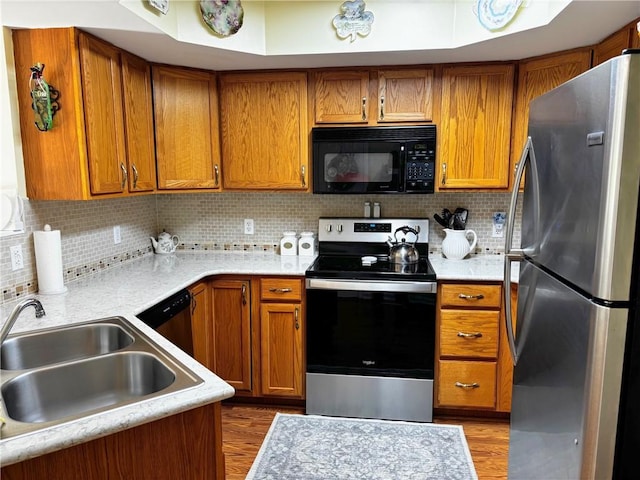 195 Rural Ave, South Strabane, PA 15301 - kitchen featuring appliances with stainless steel finishes, light countertops, and brown cabinetry