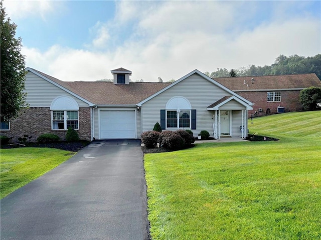 195 Rural Ave, South Strabane, PA 15301 - single story home featuring an attached garage, brick siding, a front yard, and asphalt driveway