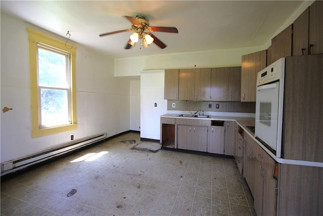 431 1st Ave, Luzerne Twp, PA 15413 - kitchen featuring a baseboard heating unit, ceiling fan, oven, and light countertops