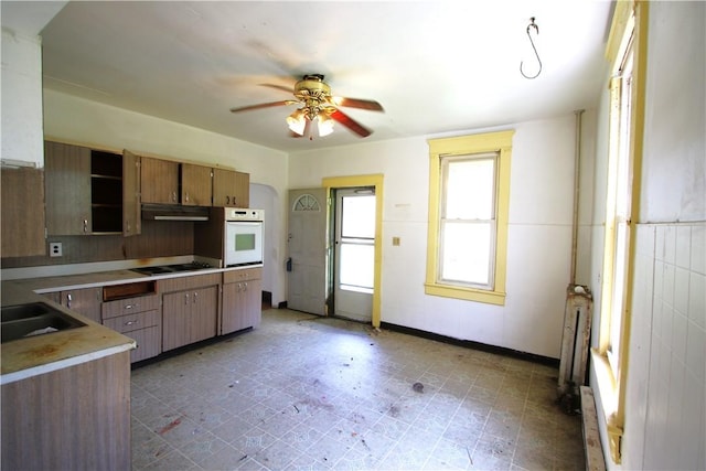 431 1st Ave, Luzerne Twp, PA 15413 - kitchen with ceiling fan, radiator heating unit, white oven, light countertops, and under cabinet range hood