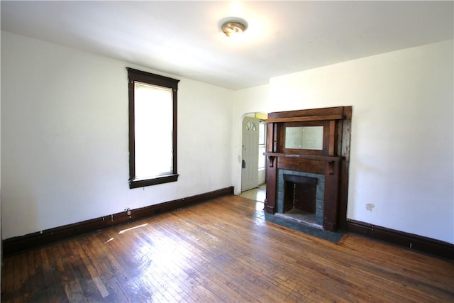431 1st Ave, Luzerne Twp, PA 15413 - unfurnished living room with arched walkways, hardwood / wood-style flooring, and a fireplace