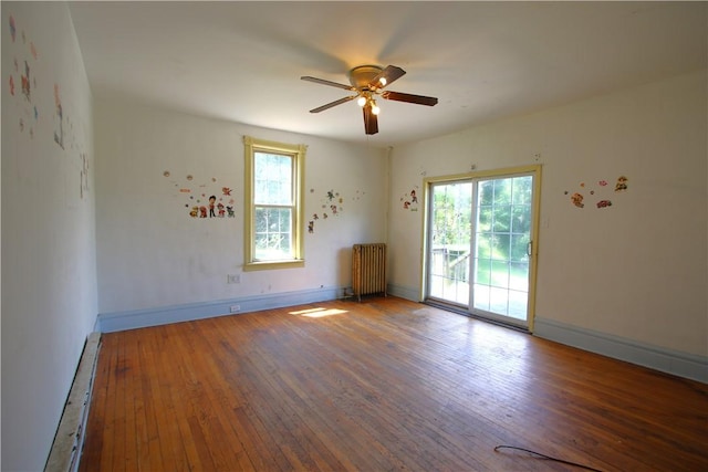 431 1st Ave, Luzerne Twp, PA 15413 - spare room featuring a baseboard heating unit, wood-type flooring, a ceiling fan, and radiator heating unit