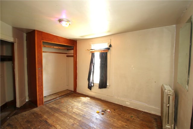 431 1st Ave, Luzerne Twp, PA 15413 - unfurnished bedroom featuring radiator heating unit, hardwood / wood-style flooring, and a closet