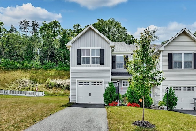 238 Smith Ln, Chippewa Twp, PA 15010 - view of front of house with board and batten siding, asphalt driveway, a front yard, and an attached garage