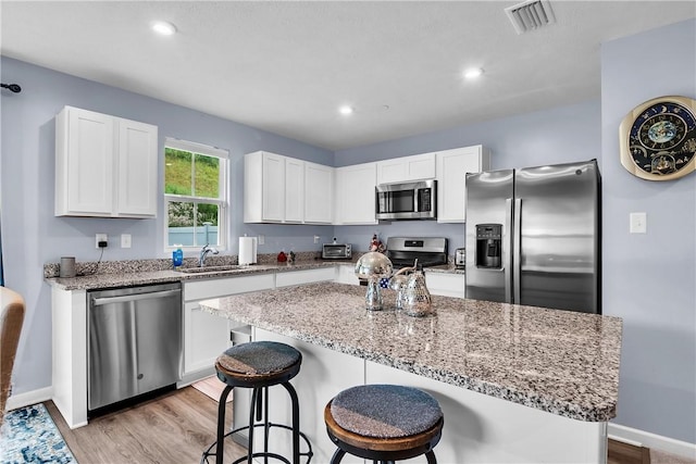 238 Smith Ln, Chippewa Twp, PA 15010 - kitchen featuring appliances with stainless steel finishes, white cabinetry, light wood-style floors, and recessed lighting