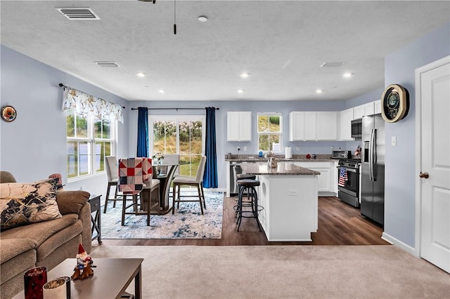 238 Smith Ln, Chippewa Twp, PA 15010 - kitchen with a center island, a kitchen breakfast bar, stainless steel appliances, white cabinets, and recessed lighting