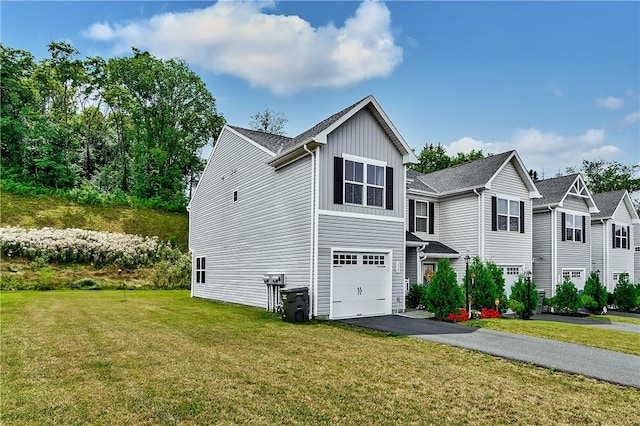 238 Smith Ln, Chippewa Twp, PA 15010 - traditional-style house featuring an attached garage, a front lawn, asphalt driveway, and board and batten siding