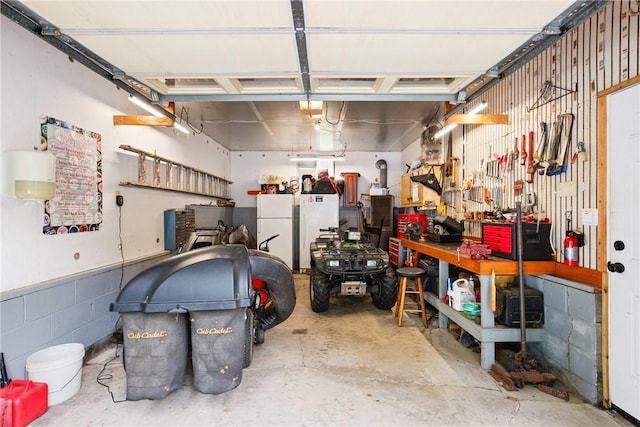 136 B St, Shade Twp, PA 15563 - garage with freestanding refrigerator and a workshop area