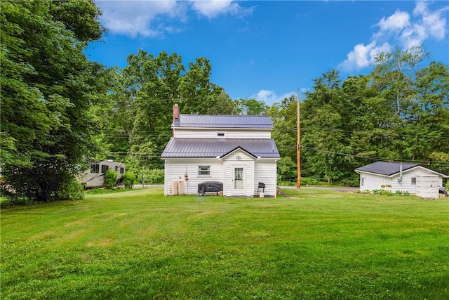 136 B St, Shade Twp, PA 15563 - back of property featuring a metal roof, a yard, and a chimney