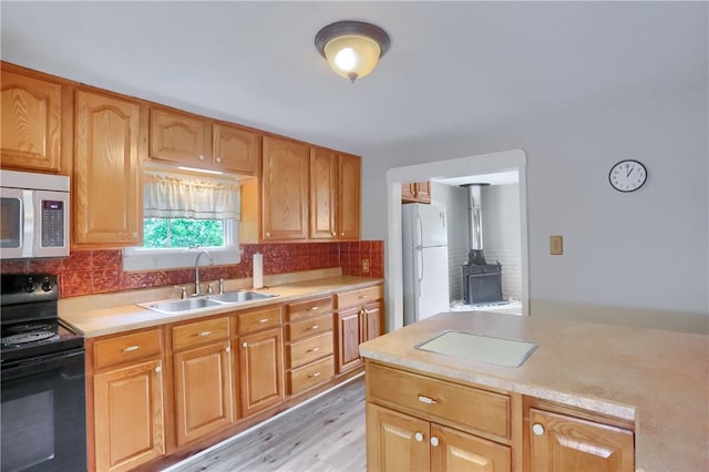 1405 Three Degree Rd, Adams Twp, PA 16059 - kitchen with black / electric stove, stainless steel microwave, light countertops, freestanding refrigerator, and backsplash