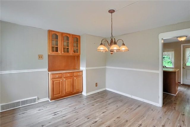 1405 Three Degree Rd, Adams Twp, PA 16059 - unfurnished dining area with light wood finished floors and a chandelier
