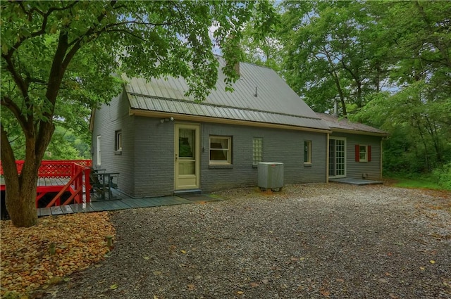 1405 Three Degree Rd, Adams Twp, PA 16059 - rear view of property featuring a metal roof, brick siding, and a deck