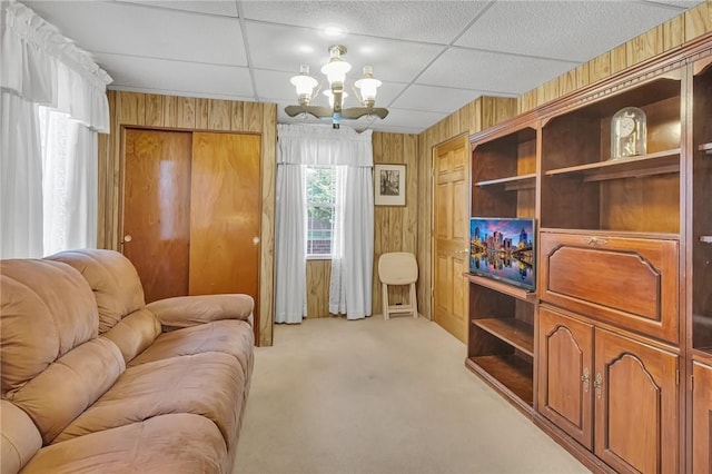 122 S Atlantic Ave, Cheswick, PA 15024 - living area featuring a chandelier, light carpet, wood walls, and a drop ceiling