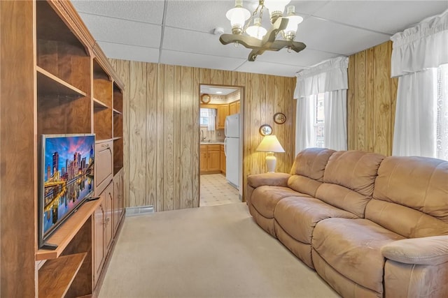 122 S Atlantic Ave, Cheswick, PA 15024 - living area featuring wooden walls, a chandelier, plenty of natural light, and light carpet