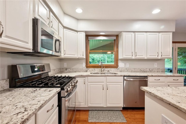 103 Cool Springs Ln, Penn Twp, PA 15636 - kitchen with stainless steel appliances, light wood-style flooring, healthy amount of natural light, white cabinetry, and recessed lighting
