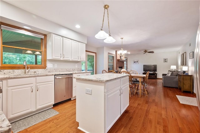 103 Cool Springs Ln, Penn Twp, PA 15636 - kitchen featuring a kitchen island, open floor plan, a fireplace, dishwasher, and white cabinets