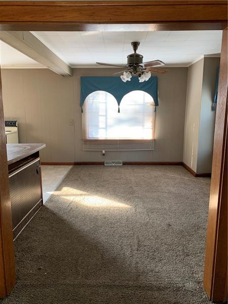 entrance foyer with beamed ceiling, washer / dryer, ceiling fan, and light colored carpet