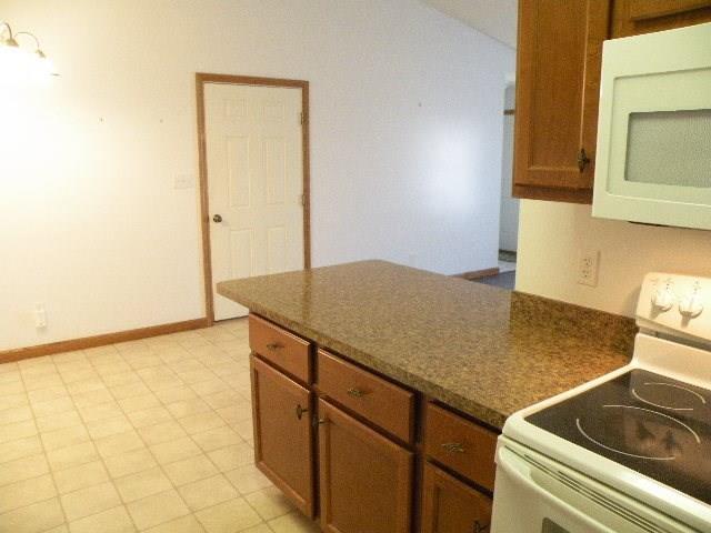 kitchen featuring white appliances and light tile floors