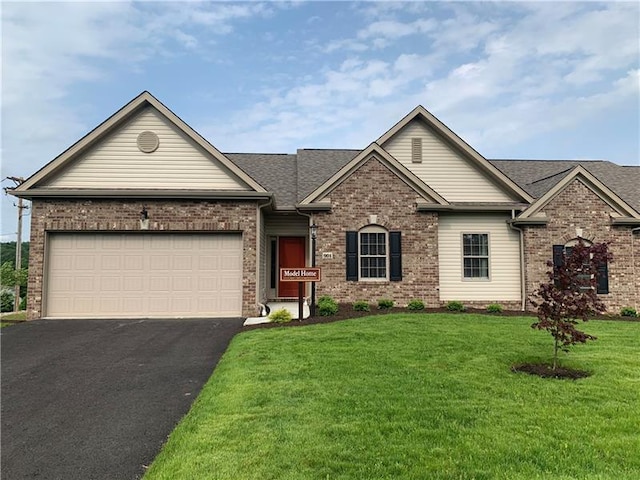 view of front of home with a front lawn and a garage