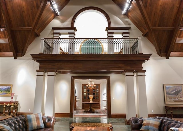 interior space featuring track lighting, wood ceiling, a chandelier, and ornate columns